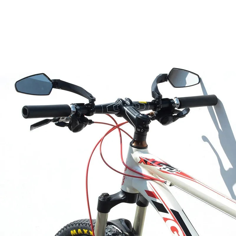 Black mountain bike rearview mirror with rotatable head mounted on bicycle handlebars showing 210mm acrylic surface