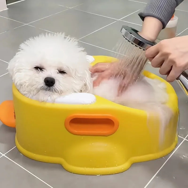 Blue PVC duck-shaped bathtub for washing dogs and cats on a lawn