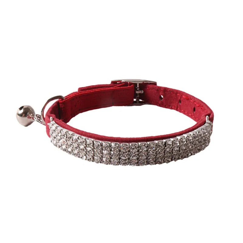 Flocked material cat collar with elastic buckle in assorted colours on a white background.
