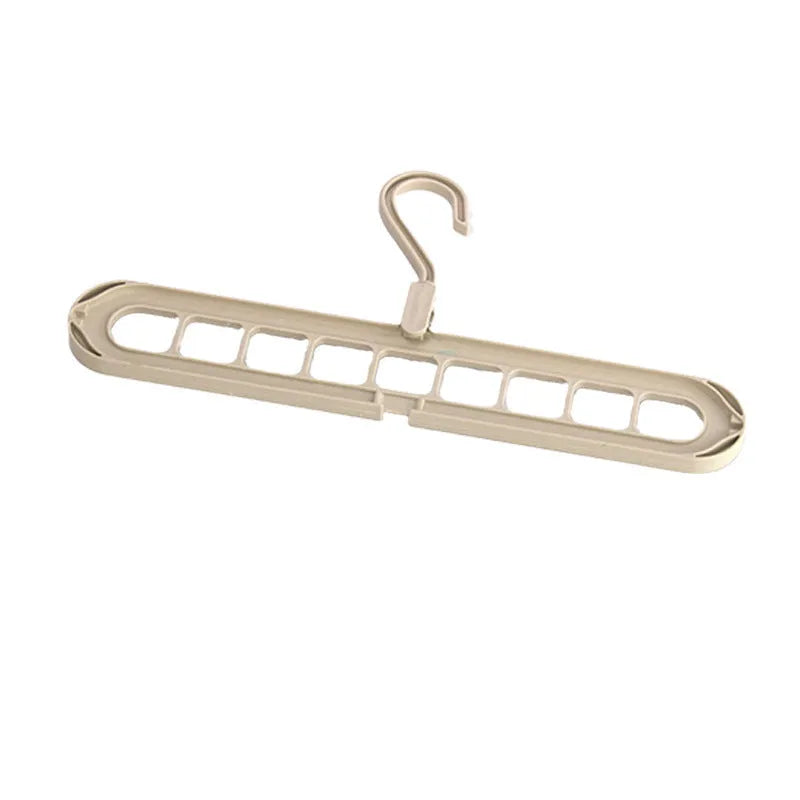 Green plastic nine-hole trousers hanger for wardrobe organisation with modern minimalist design