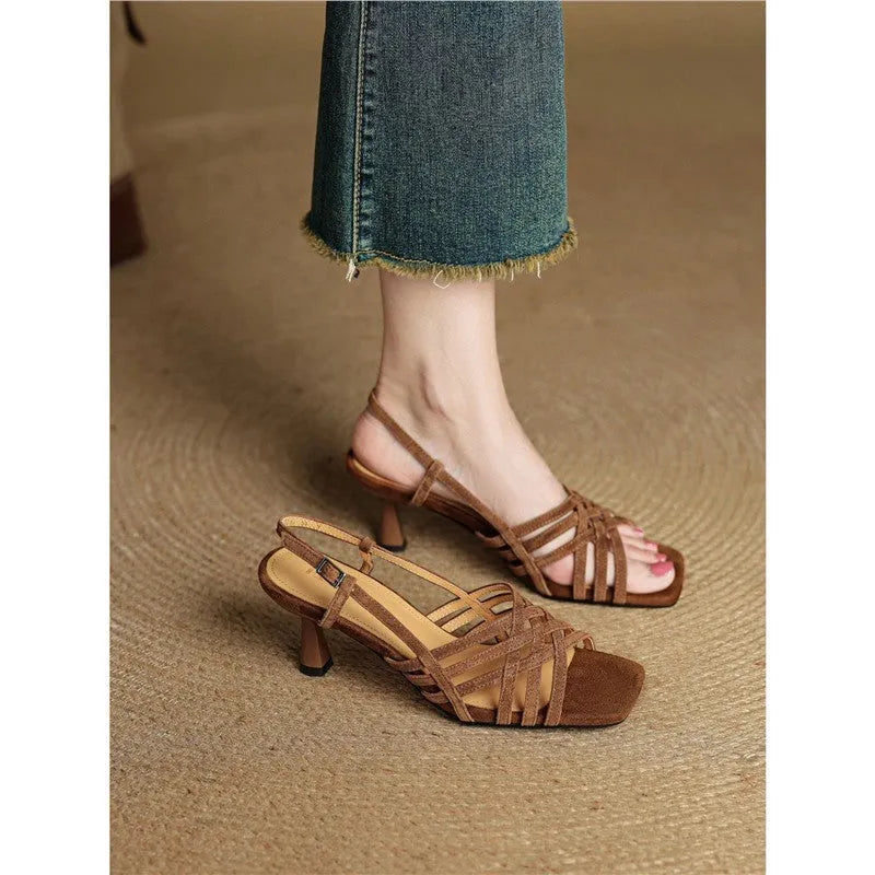 Retro women's high heel sandals with thin brown cross straps and an ankle buckle on a square toe.