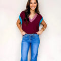 Burgundy women's loose sweater with V-neck and contrast trim cuffed short sleeves