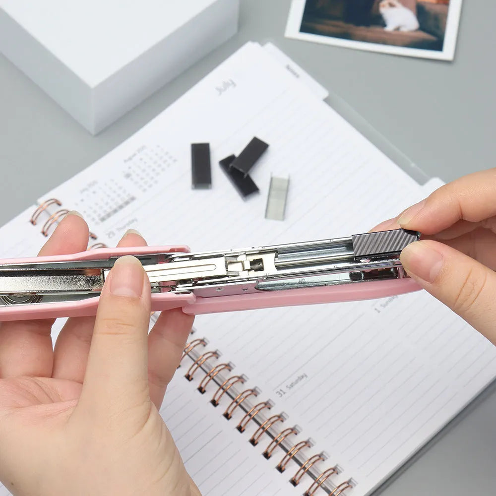 Box of 1000 metal office staples in rose gold, black, purple, and rose red colour options.