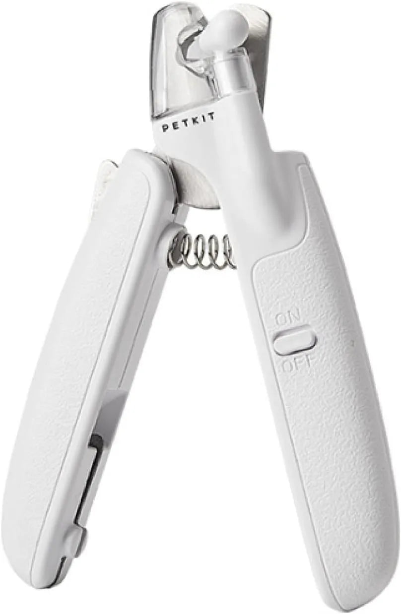 White pet nail clippers with LED light, transparent anti-splash guard, and leather-like handle on a table
