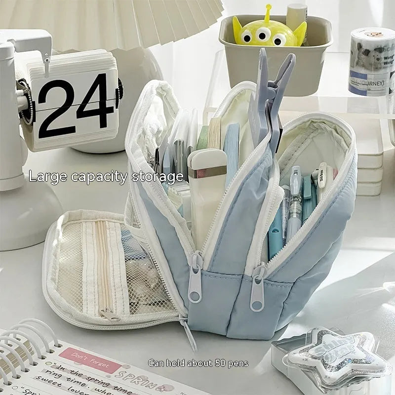 Double layer high-capacity pencil case in solid colour with gift handle, shown open to reveal two compartments.