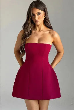 Women's black backless tube dress with high-waist A-line short skirt on a mannequin.
