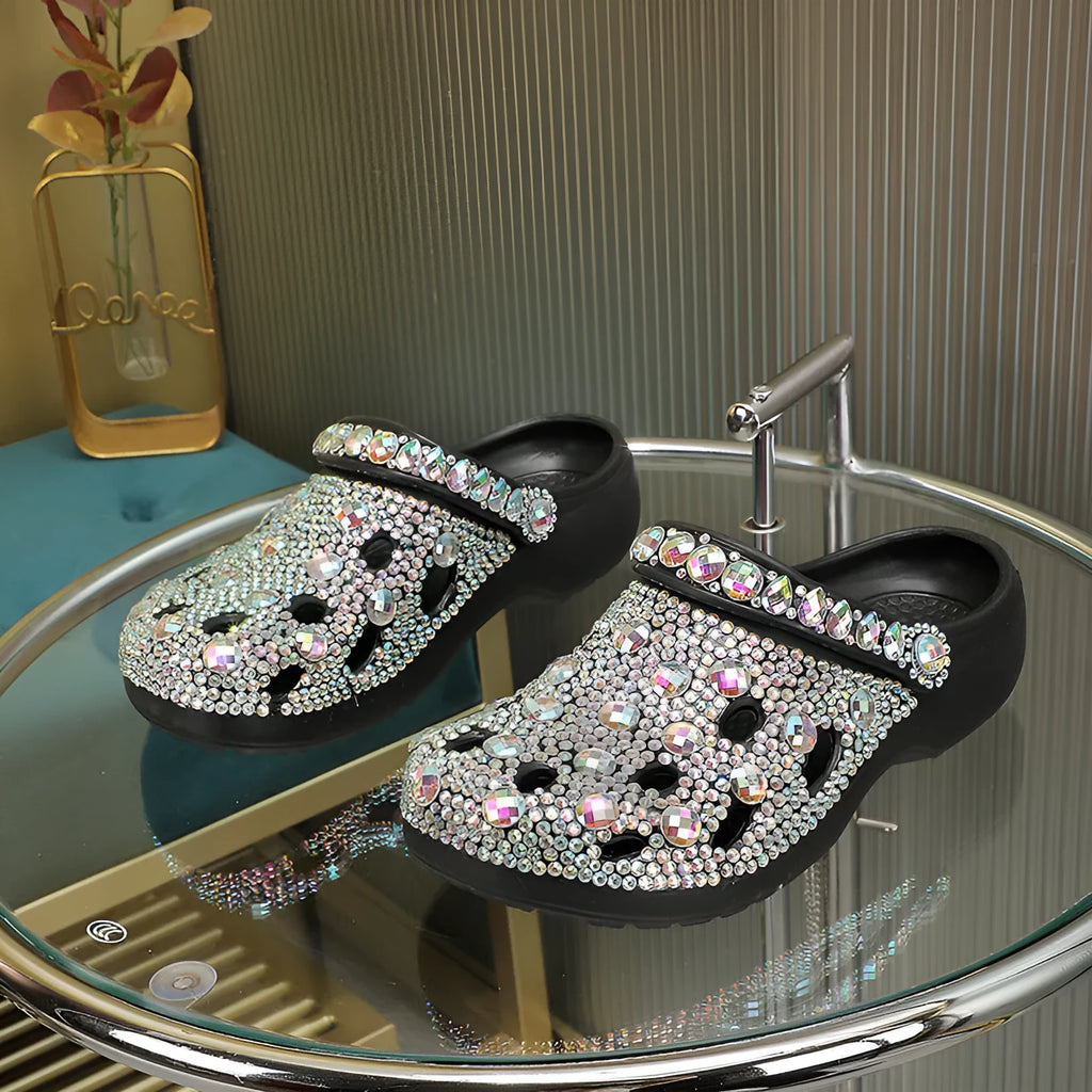 Black women's platform sandals with a perforated design and rhinestone details on the EVA upper.