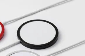 Silver metal Magsafe magnetic wireless charger for iPhone 12 and iPhone 13 models with USB cable.