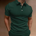 Man wearing a loose fit gray cotton blend t-shirt with a button detail and short sleeves.