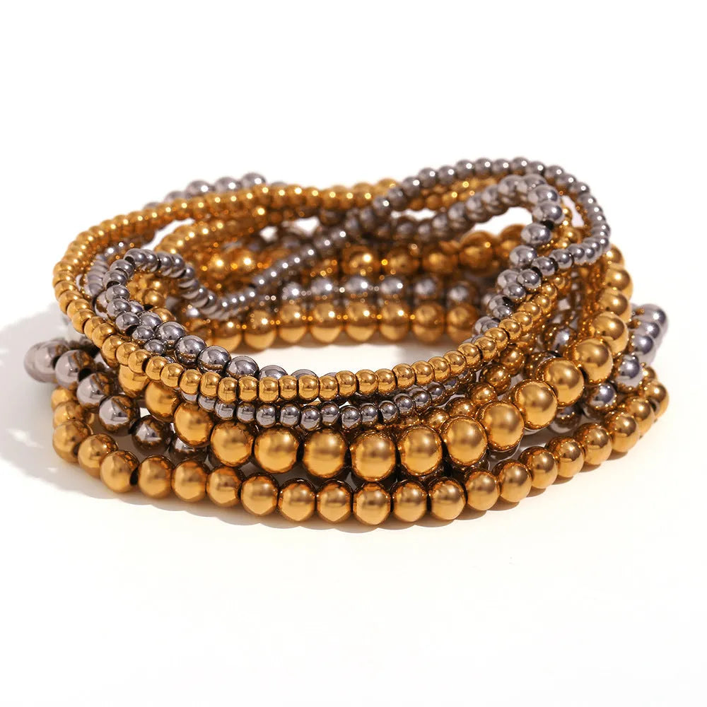 Stainless steel plated elastic bead bracelet with round geometric beads in gold finish