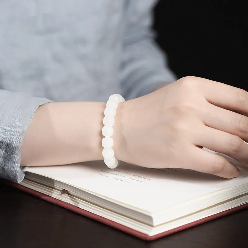 White Hetian jade barrel bead bracelet showing smooth pale stone beads in uniform barrel shape