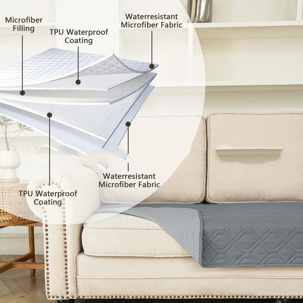 Reversible waterproof dog sofa cushion in dark grey and light grey, shown on a sofa.