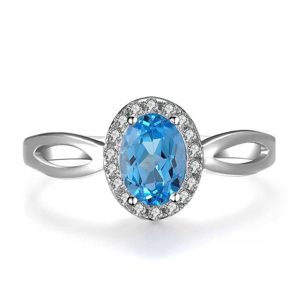 Women's 925 sterling silver and blue topaz four-piece jewellery set with geometric design, showing earrings, ring, necklace, and pendant.