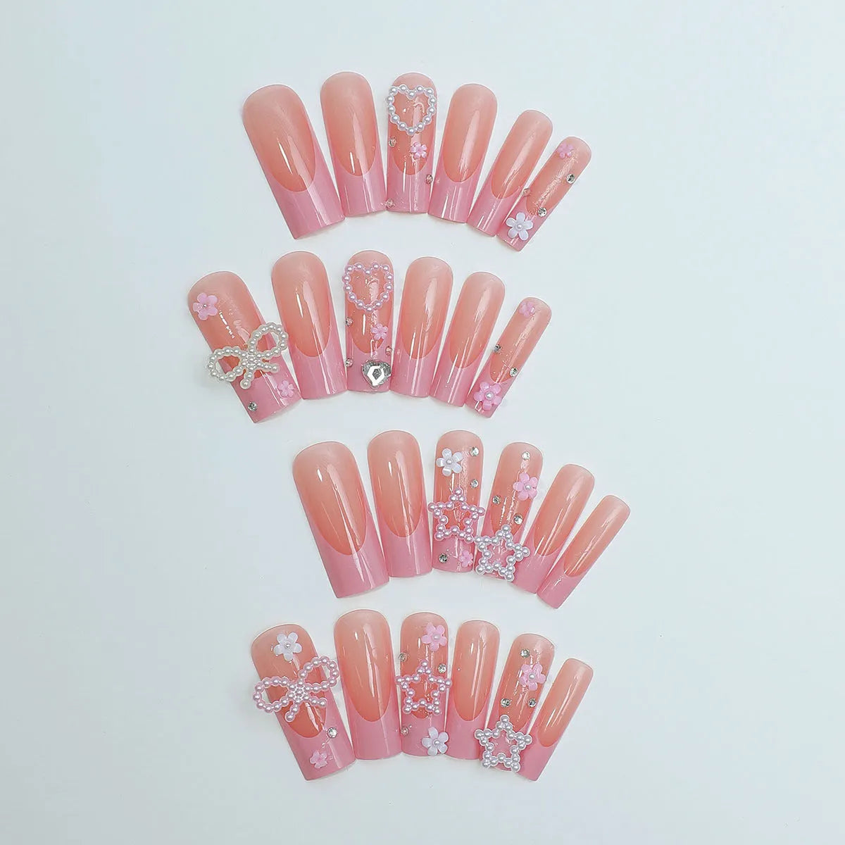 Close-up of a love pattern bow nail decoration in colour XB-70-48 on a nail.
