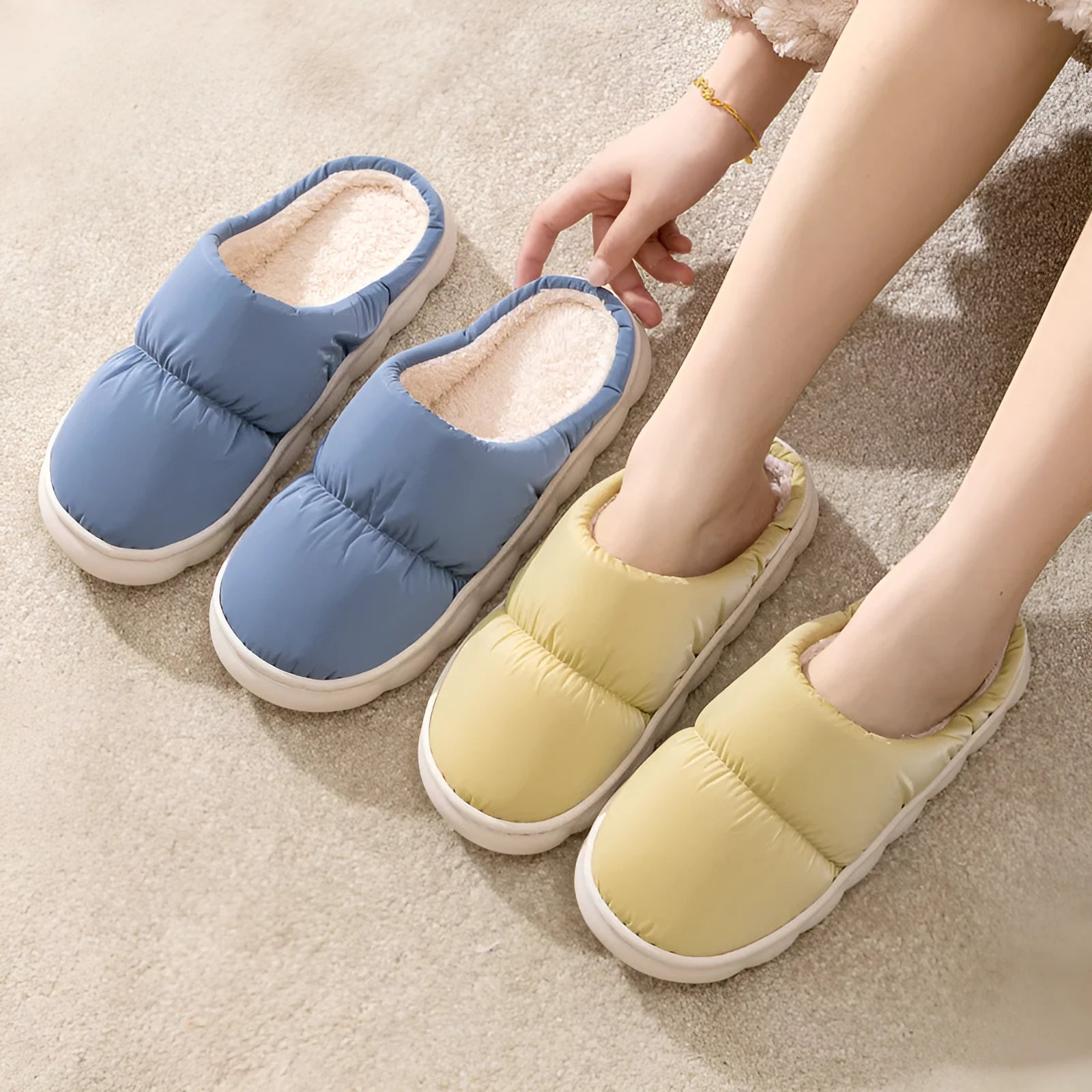 Pair of down cotton winter slippers with artificial leather upper, plush lining, and thick rubber sole.