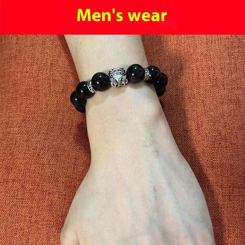 Natural obsidian and Silver 999 Cloud Year bracelet in simple unisex style on wrist.
