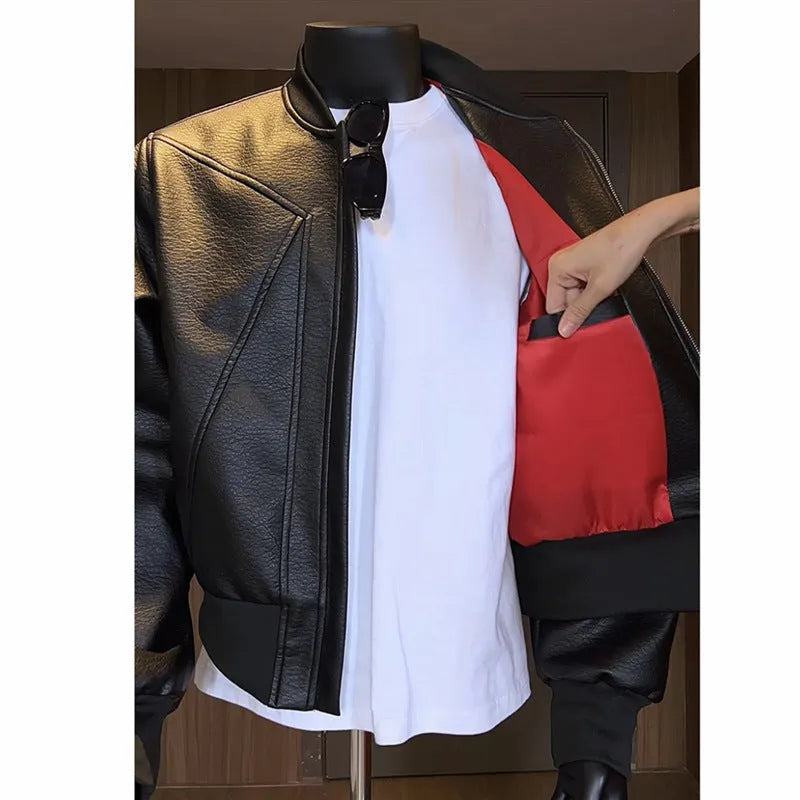 Man wearing a black PU egg white leather jacket with an extended length and tight light business fit.