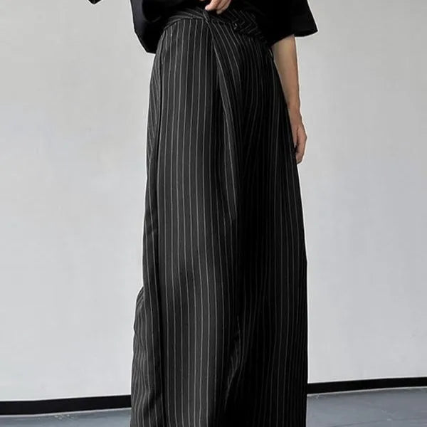 Black men's trousers with vertical striped pleated design showing elastic casual wear