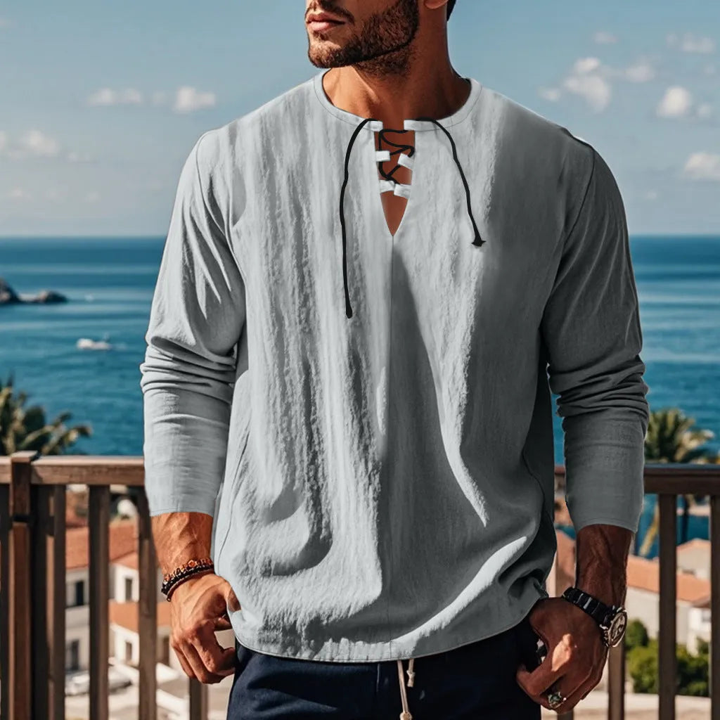 A solid colour cotton linen beach ruff shirt in a loose fit pullover style with short sleeves.