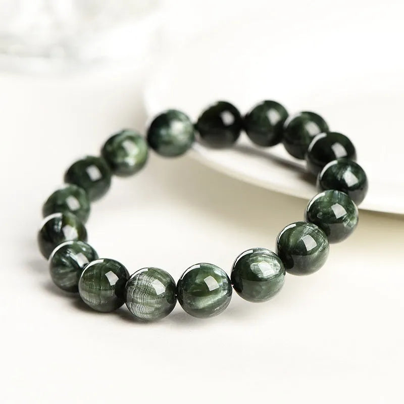 Green Dragon Crystal bracelet with Ruyi design and 8-9mm round beads on a wrist.
