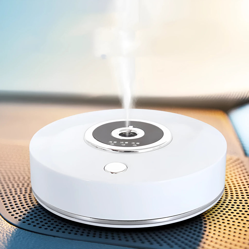 White plastic USB car air freshener diffuser with charging cable and anti-slip pad on a car dashboard.