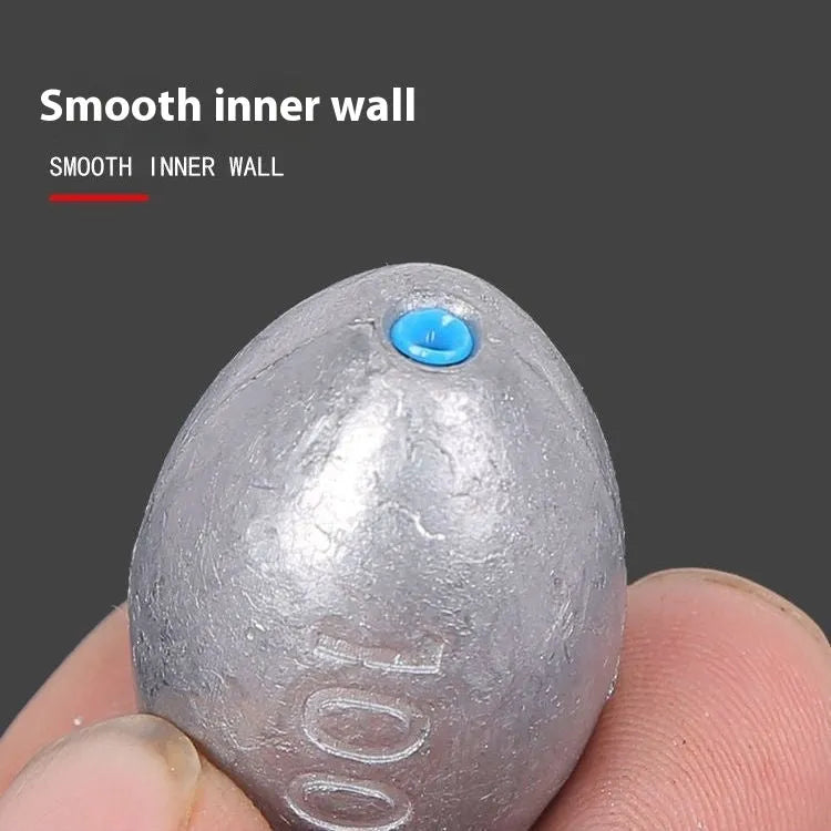 Close-up of a rugby-shaped olive lead fishing sinker with a Tongxin scale pattern texture.