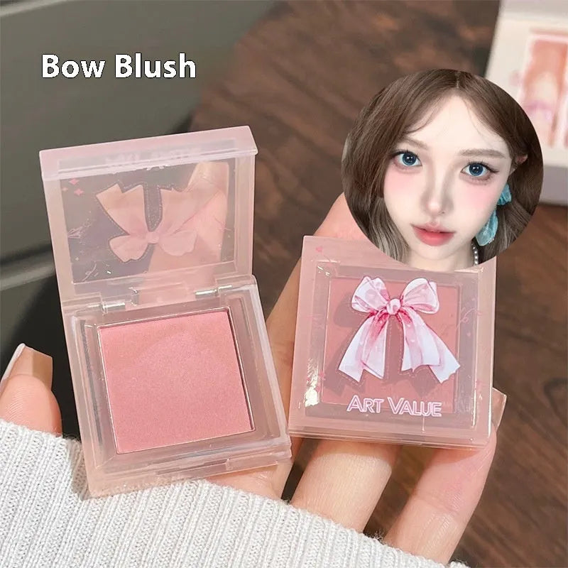 Butterfly Box makeup set with four lip mud tubes, powder blusher compact, and matching necklace on pink background