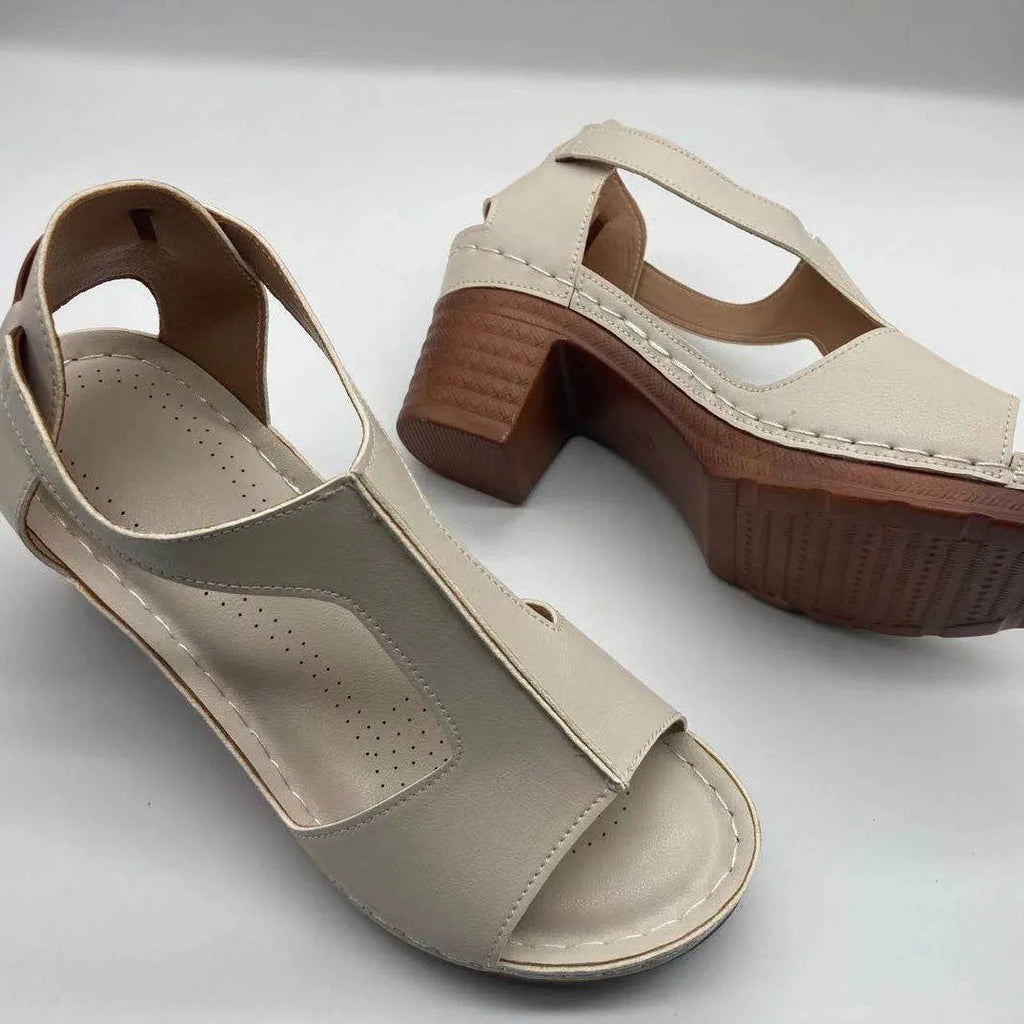 Women's plus size beige peep toe wedge sandals with a buckle strap and low heel.