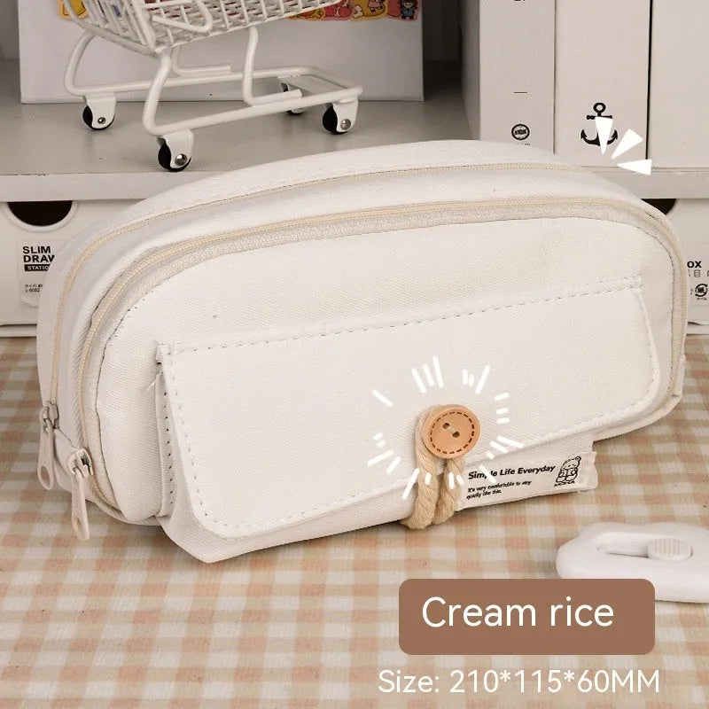 Korean style canvas pencil case in beige, blue, grey, or green holding multiple pens