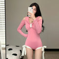 Women's long-sleeved one-piece swimsuit in polyester fibre available in pink and black colours