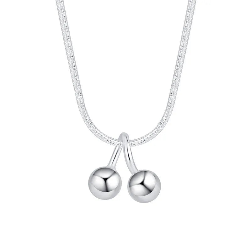 Silver cherry pendant necklace with adjustable snake bone chain on a 21cm to 50cm range.