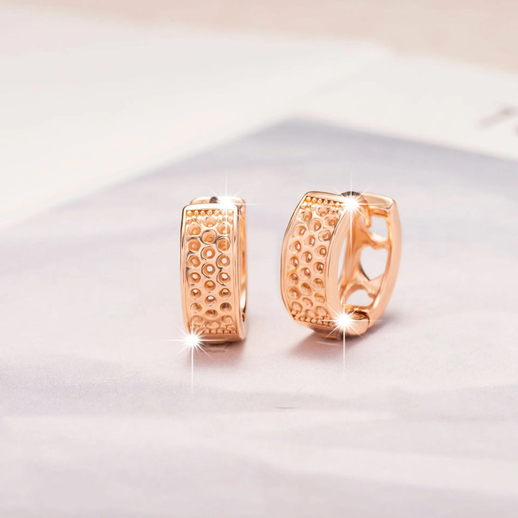 Rose gold electroplated earrings with three hollowed out hearts in circular arrangement