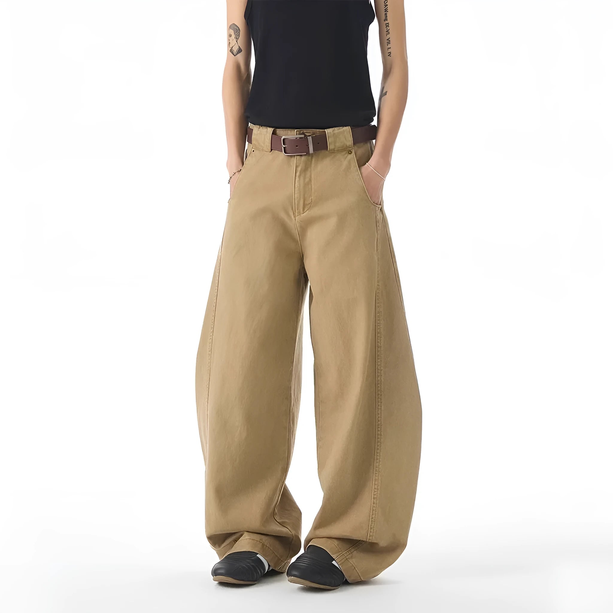 Man wearing brown loose-fit straight leg jeans with a mid waist and button fly.