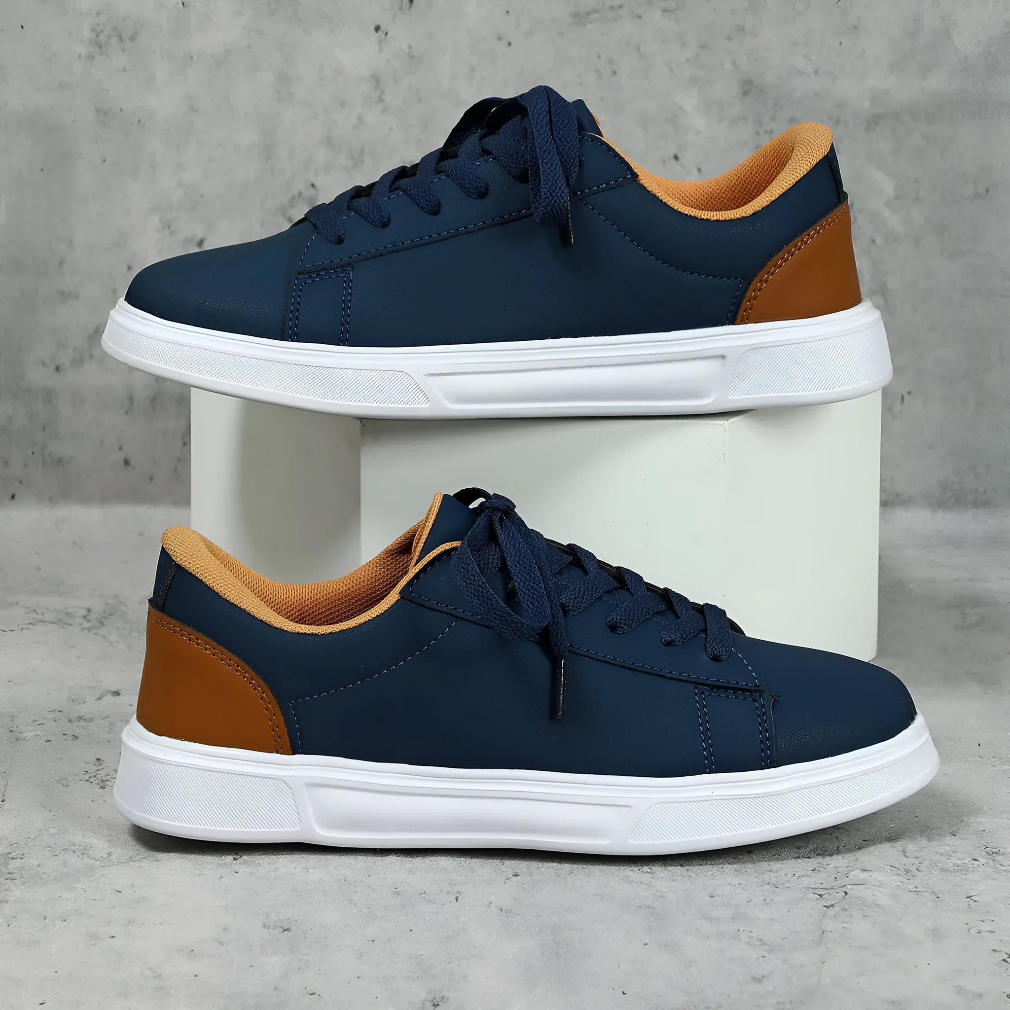 Beige brown casual platform sneakers with a cross strap and round toe on a rubber sole.