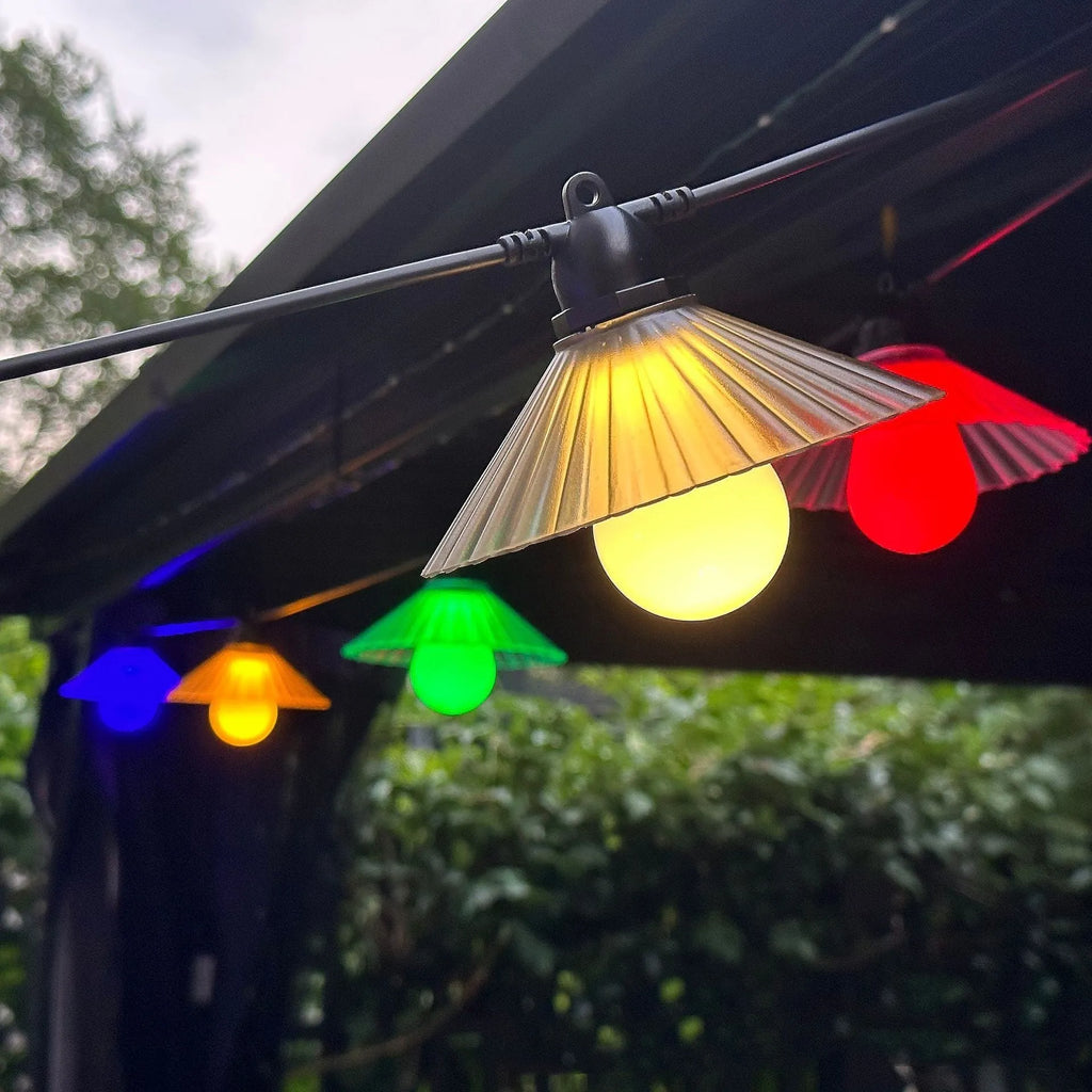 Outdoor LED string lights with flower-shaped globes, showing IP65 waterproof rating and 5V low voltage operation.