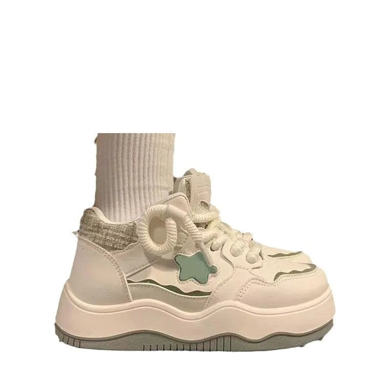 Women's green platform sneakers with patent leather finish, round toe, and lace-up front