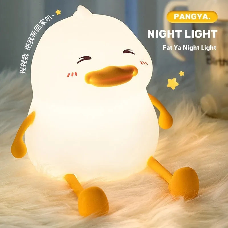 Chubby Night Light silicone desk lamp and mobile phone holder on a wooden surface.