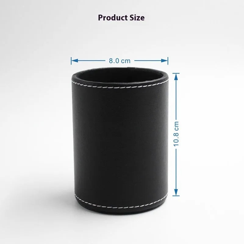 Round black leather pen holder container on desk with pens inside