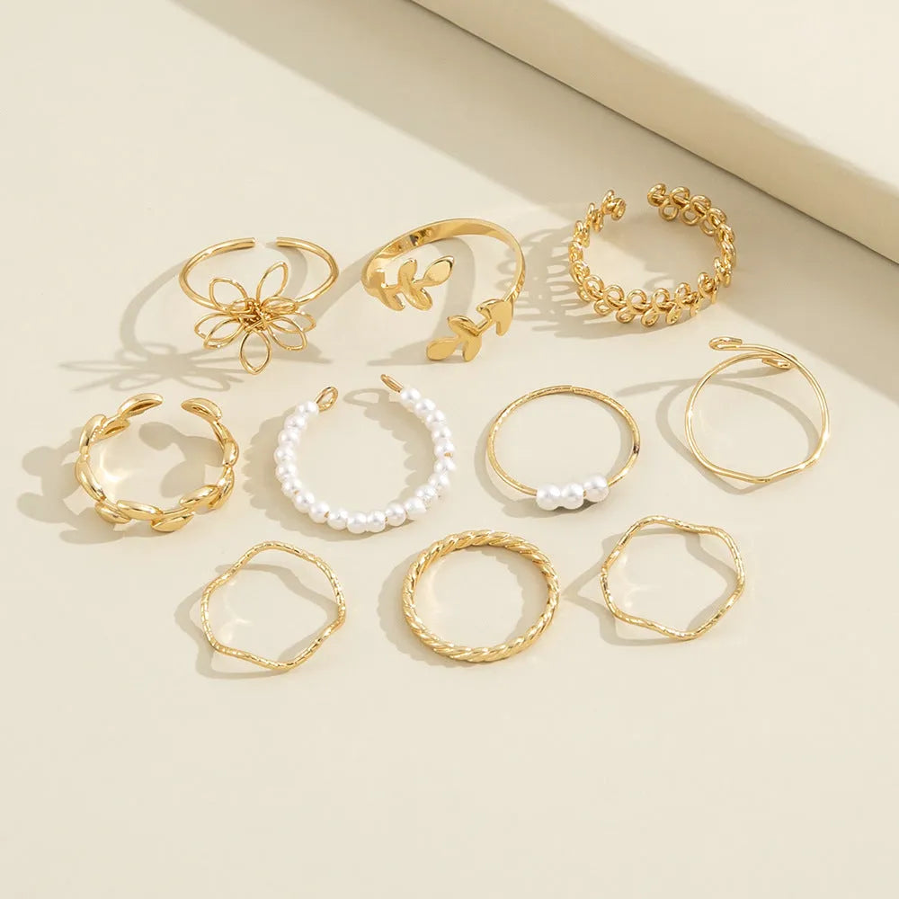 Openwork flower ring set with glossy gold finish and detailed floral pattern