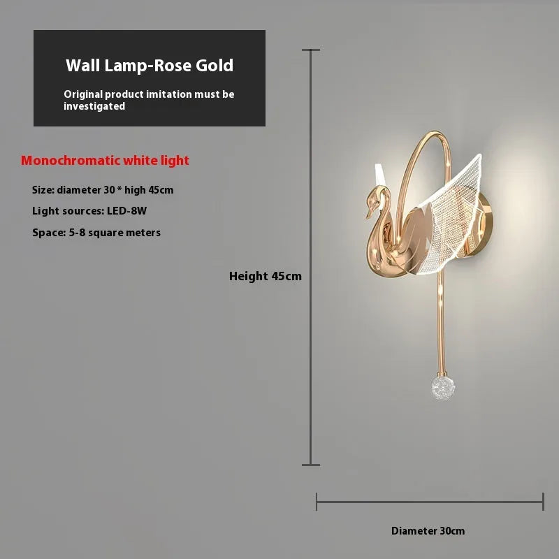 Gold minimalist swan-shaped wall lamp with an acrylic shade mounted on a wall.