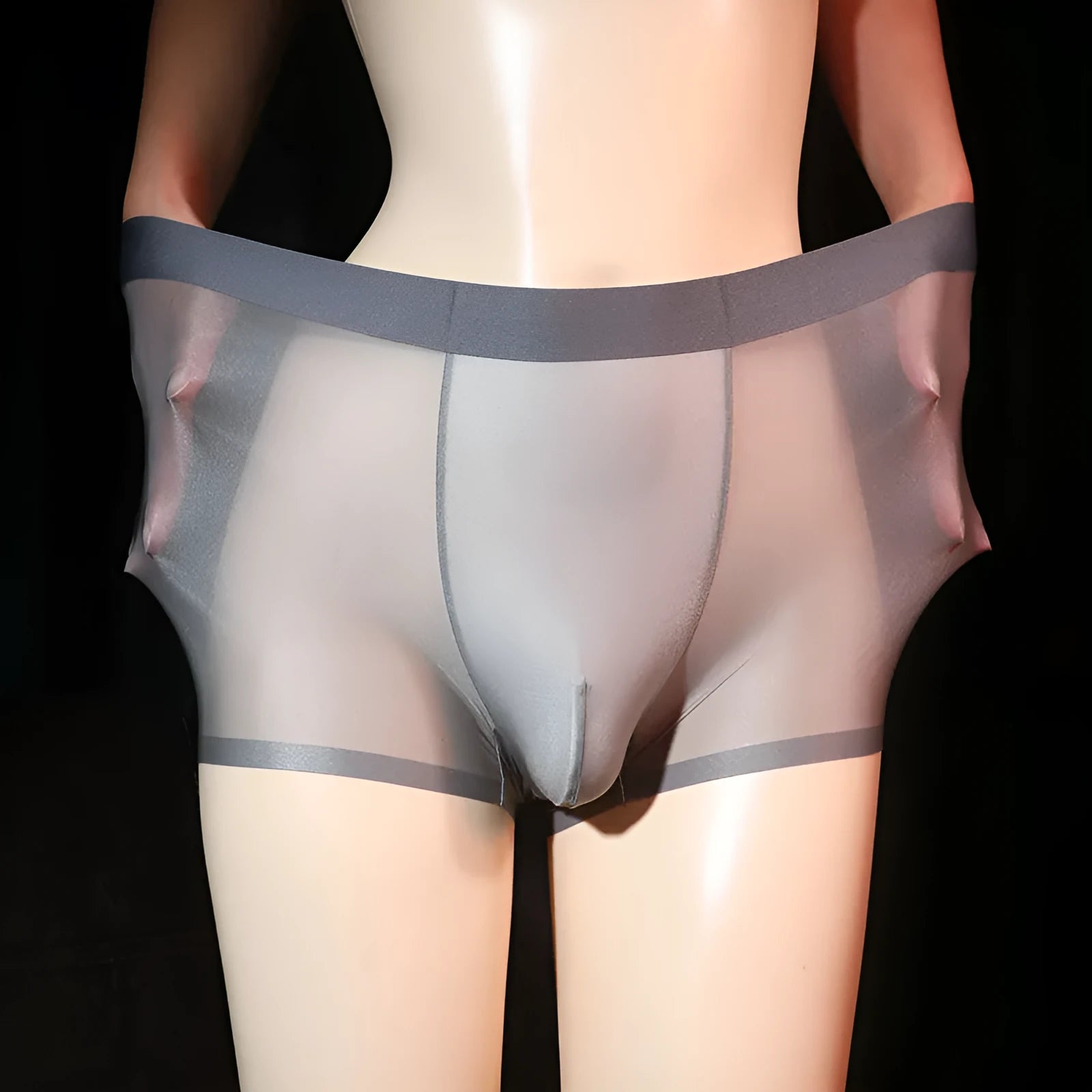 Ultra-thin transparent men's ice silk boxer shorts in light grey on a size chart.