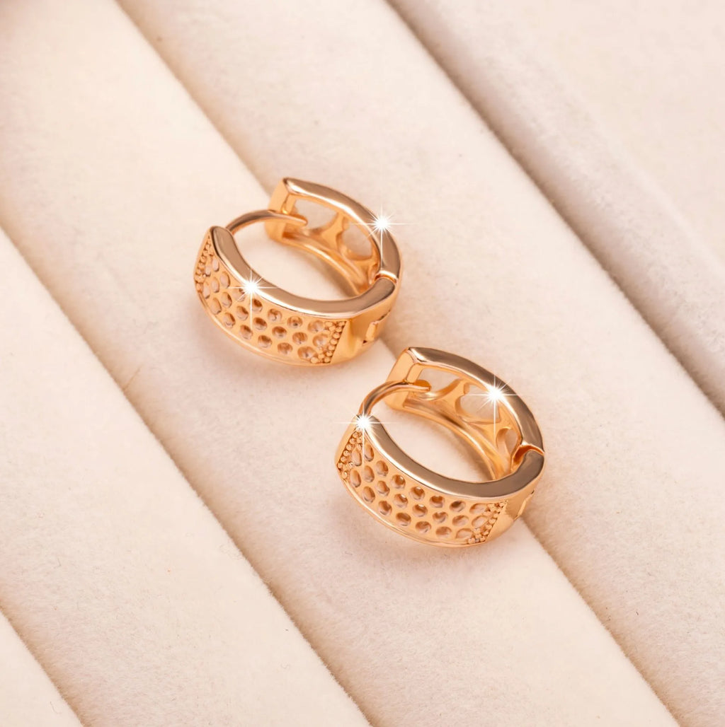 Rose gold hollowed-out heart drop earrings with a circular silhouette on a white background.