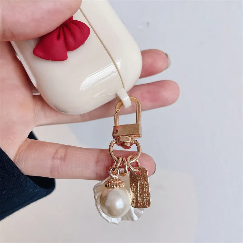 Beige red bow shell coloured TPU clamshell case cover for Apple AirPods charging case.