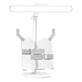 Multifunctional adjustable table lamp on a bookshelf showing three colour temperature settings and dual charging plug