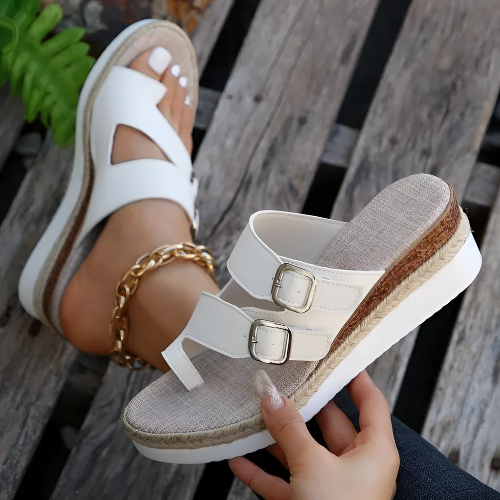 White patent leather wedge sandals with woven design and finger fit straps