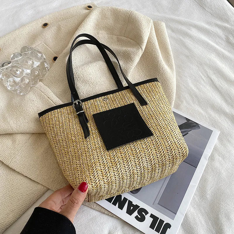 Straw woven women's shoulder bag with retro design showing three-dimensional pockets and 18cm handle