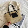 Straw woven women's shoulder bag with retro design showing three-dimensional pockets and 18cm handle