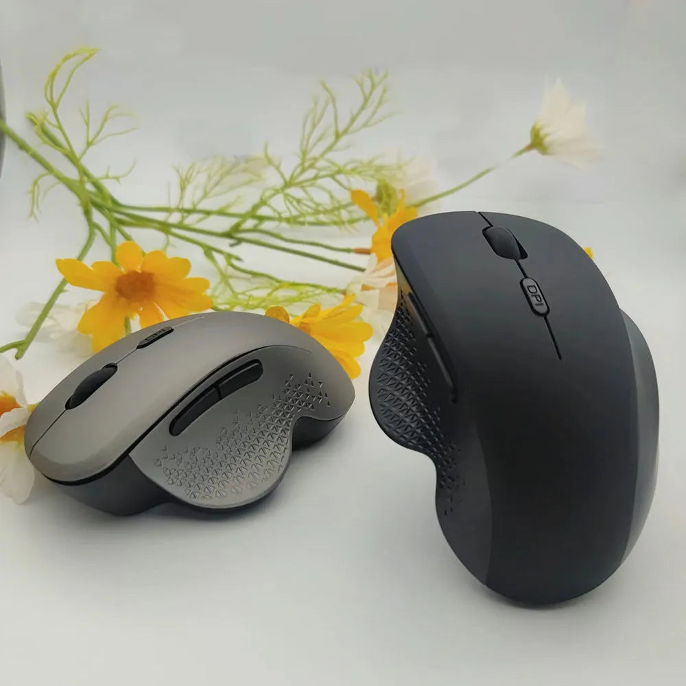 Grey and black wireless USB-charging laptop mouse with cable on a white background.
