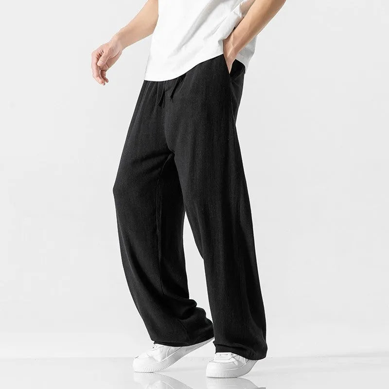 Men's beige bamboo fibre linen trousers with a straight leg, cropped length, and drawstring waist on a mid-rise.