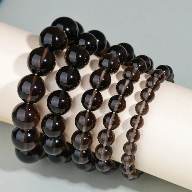 Hand-woven black obsidian bracelet showing round crystal beads in 8mm to 16mm diameter options with ethnic unisex styling
